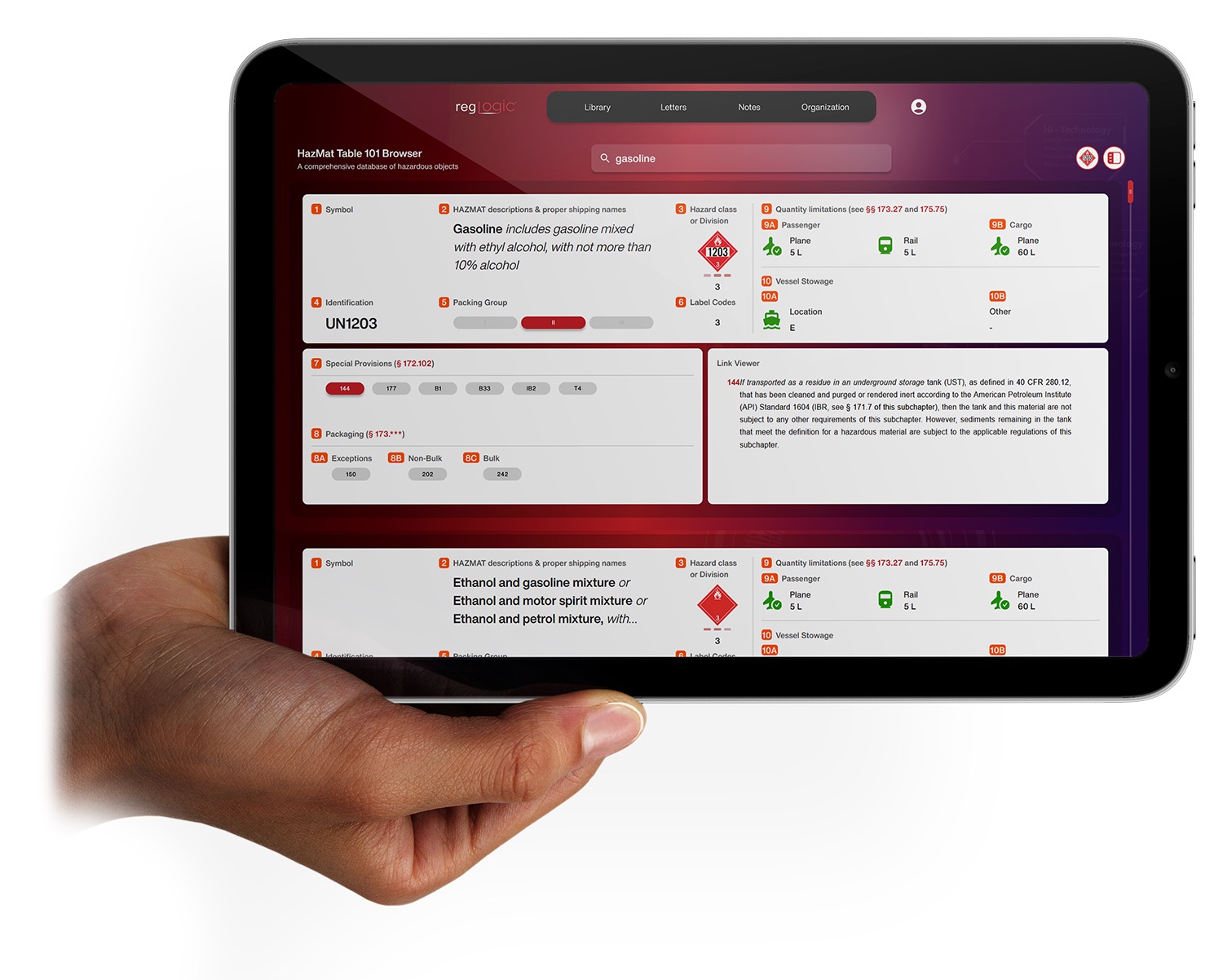Hand holding tablet displaying RegLogic application at a trucking terminal